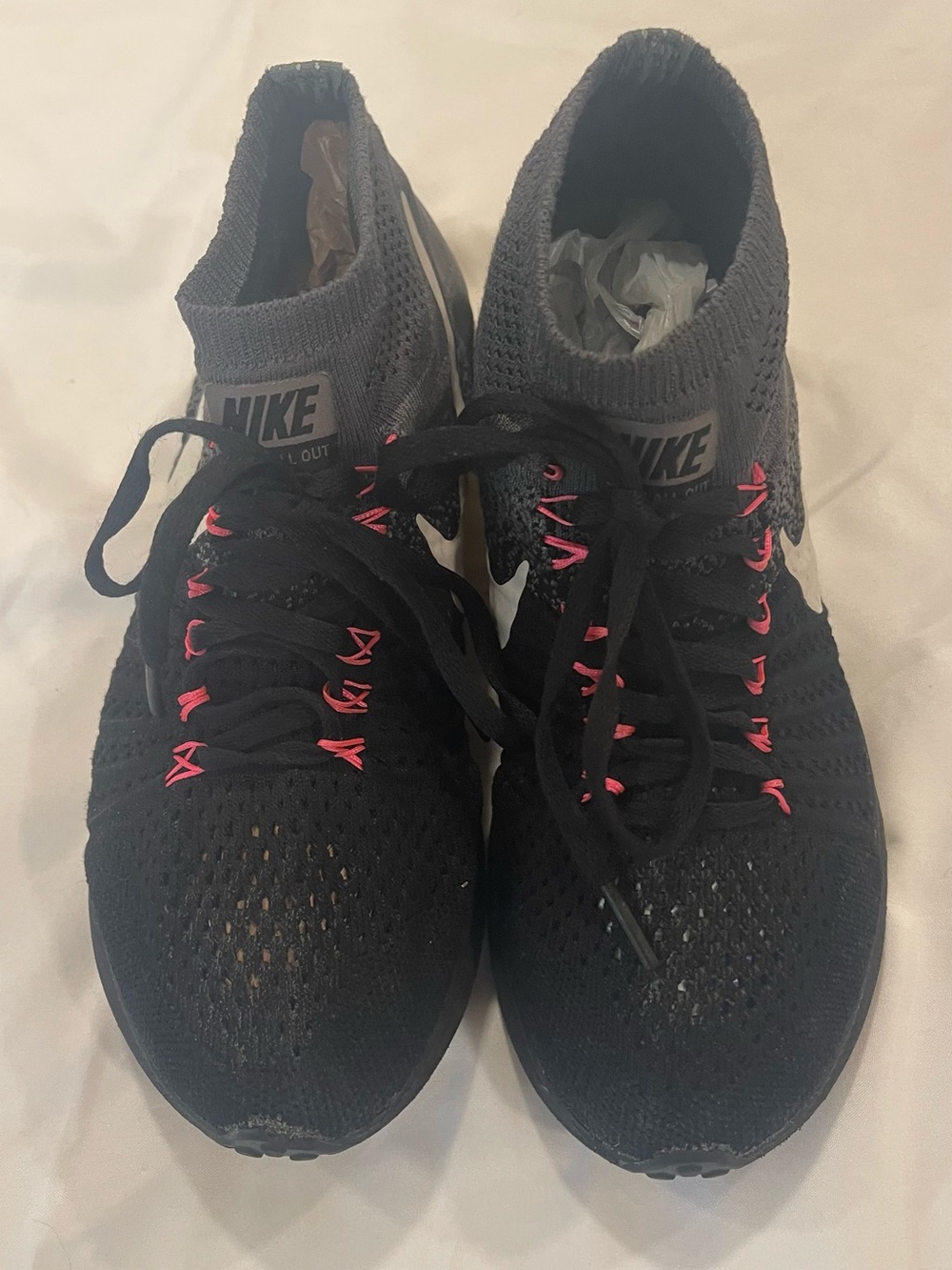 Nike Women’s Black Flyknit Sneakers with Pink Lace Details